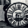 Tomi Ungerer avec un cadran d’horloge monumentale de la firme Ungerer - Vers 1990-1993 – Photographie Archives du Musée Tomi Ungerer – Centre international de l’Illustration, Strasbourg © Musées de la Ville de Strasbourg 
